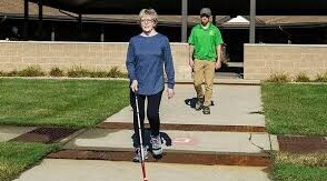 Woman learning to use white cane